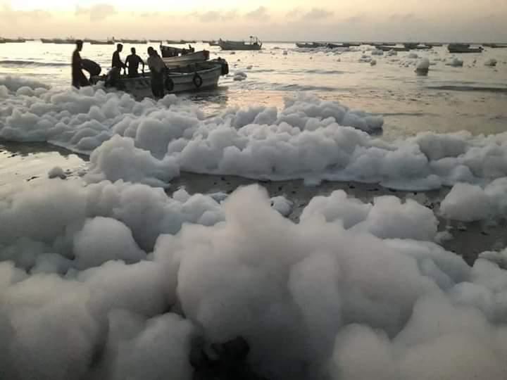 Harmless foam floats at the beach of Liido